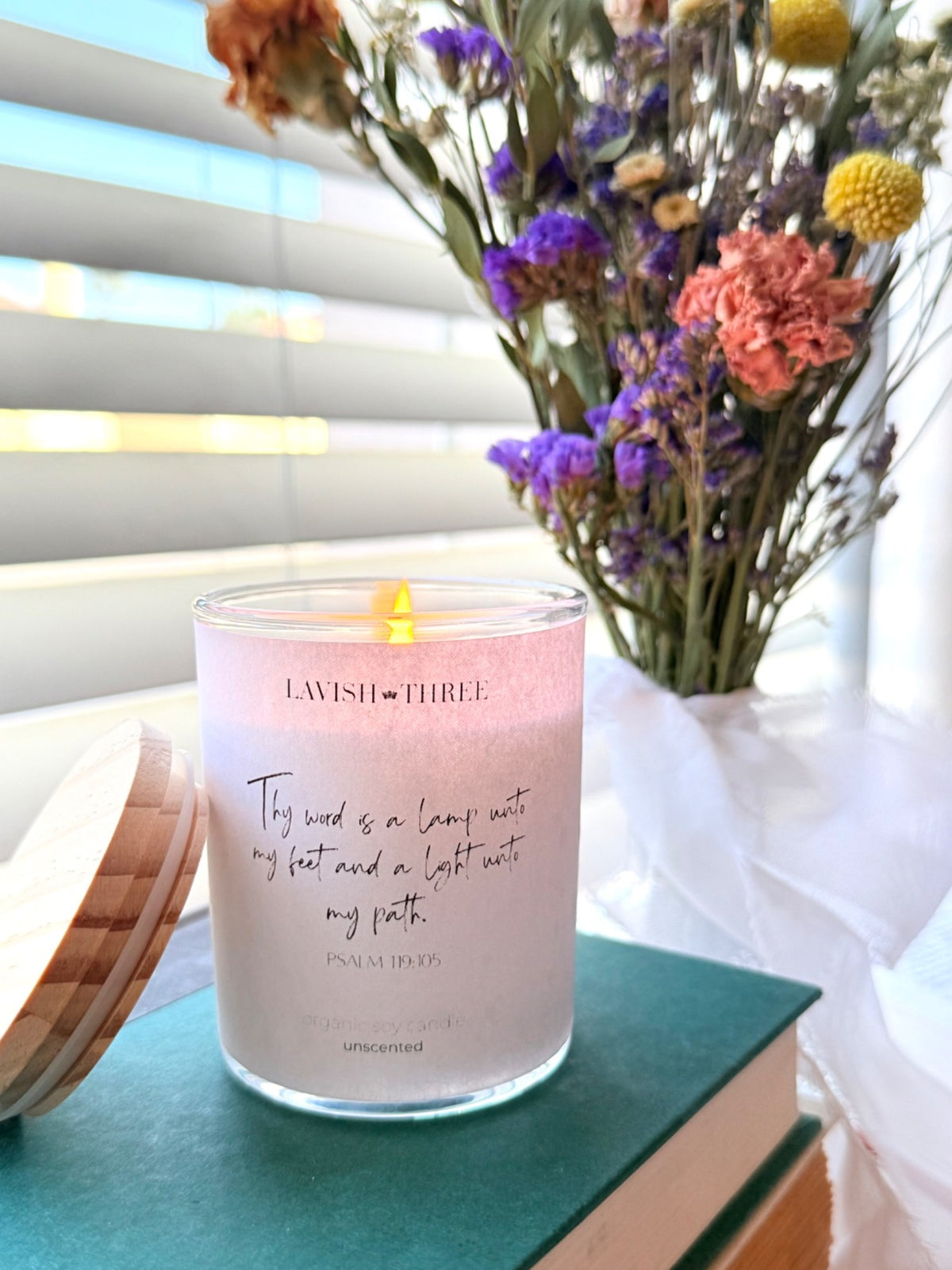 Lavish Three scripture candle styled with dried flowers on books