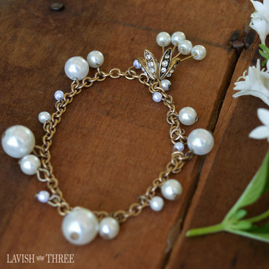 Gold and perel bracelet with gold flower charm